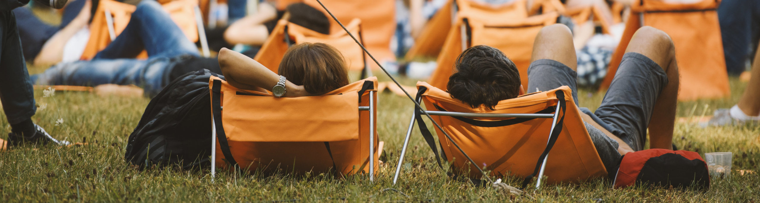 Couple relaxing in lounge chairs at a summer concert