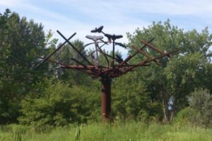 Steel tower rising above the gardens in a large nest-like shape