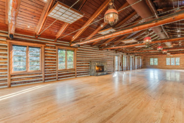 The interior of an empty log cabin venue at Hudson Gardens in Littleton, Colorado