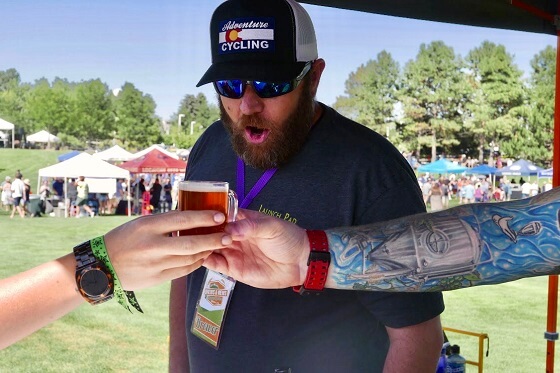 a brewer gazes longingly at a sample of beer at a denver area beer festival
