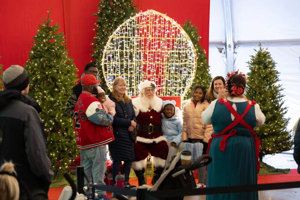 Family posing for photo with Santa