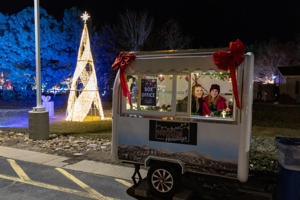 Ticket booth trailer with two people smiling inside