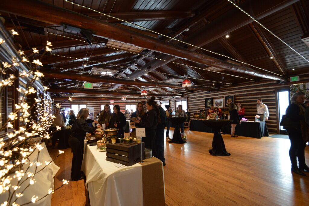 Vendor tables set up in log cabin-style event space