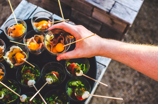 Hand reaching for tray of appetizers